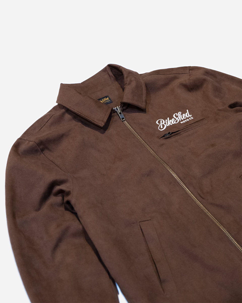 Brown twill motorcycle jacket with a Bike Shed Moto Co brand logo on a white background